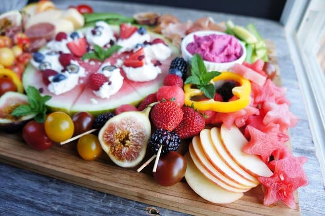 close up shot of figs and apples on fruit charcuterie board