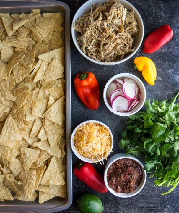 Game day snacks aren't complete without a big sheet pan of crispy cheesy goodness! Complete your tailgate menu with these pulled pork nachos.