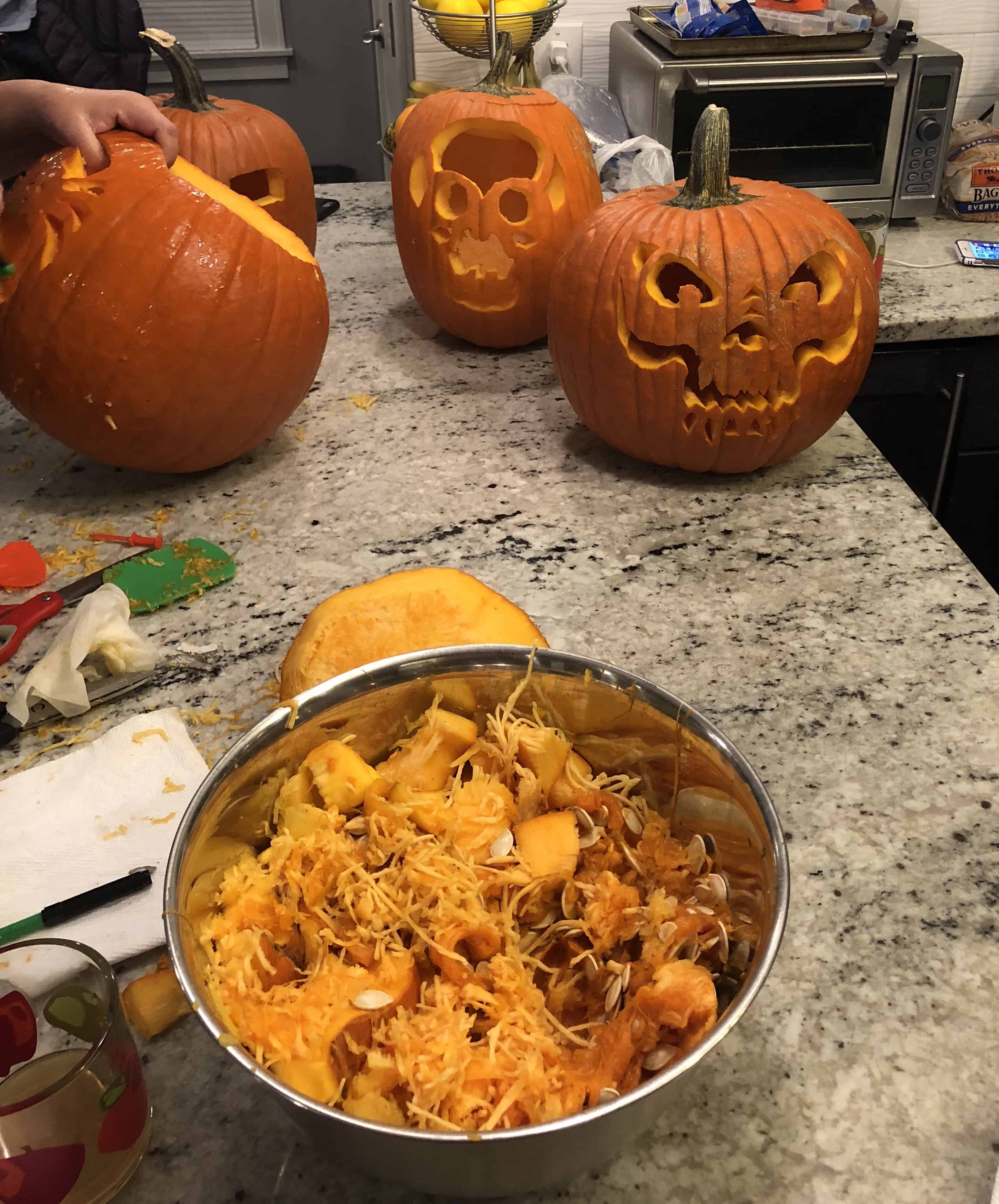 Halloween Trail Mix | Delicious blend of salty and sweet, this recipe for Halloween Trail Mix is perfect for a Fall snack or Halloween party! carved pumpkins and seeds in bowl