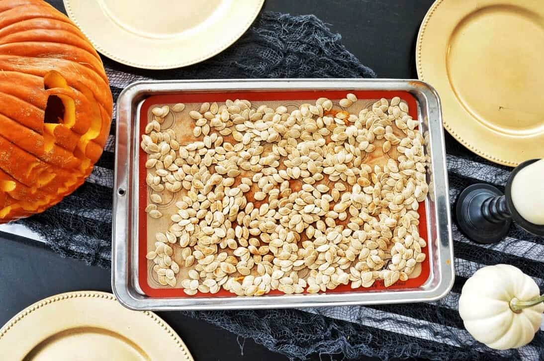 Halloween Trail Mix | Delicious blend of salty and sweet, this recipe for Halloween Trail Mix is perfect for a Fall snack or Halloween party! pumpkin seeds on baking sheet
