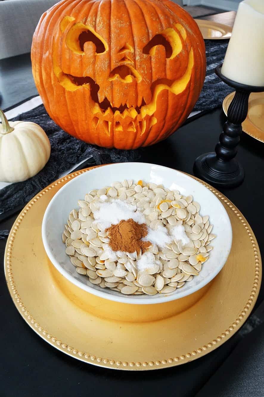 Halloween Trail Mix | Delicious blend of salty and sweet, this recipe for Halloween Trail Mix is perfect for a Fall snack or Halloween party! raw pumpkin seeds with spices on top
