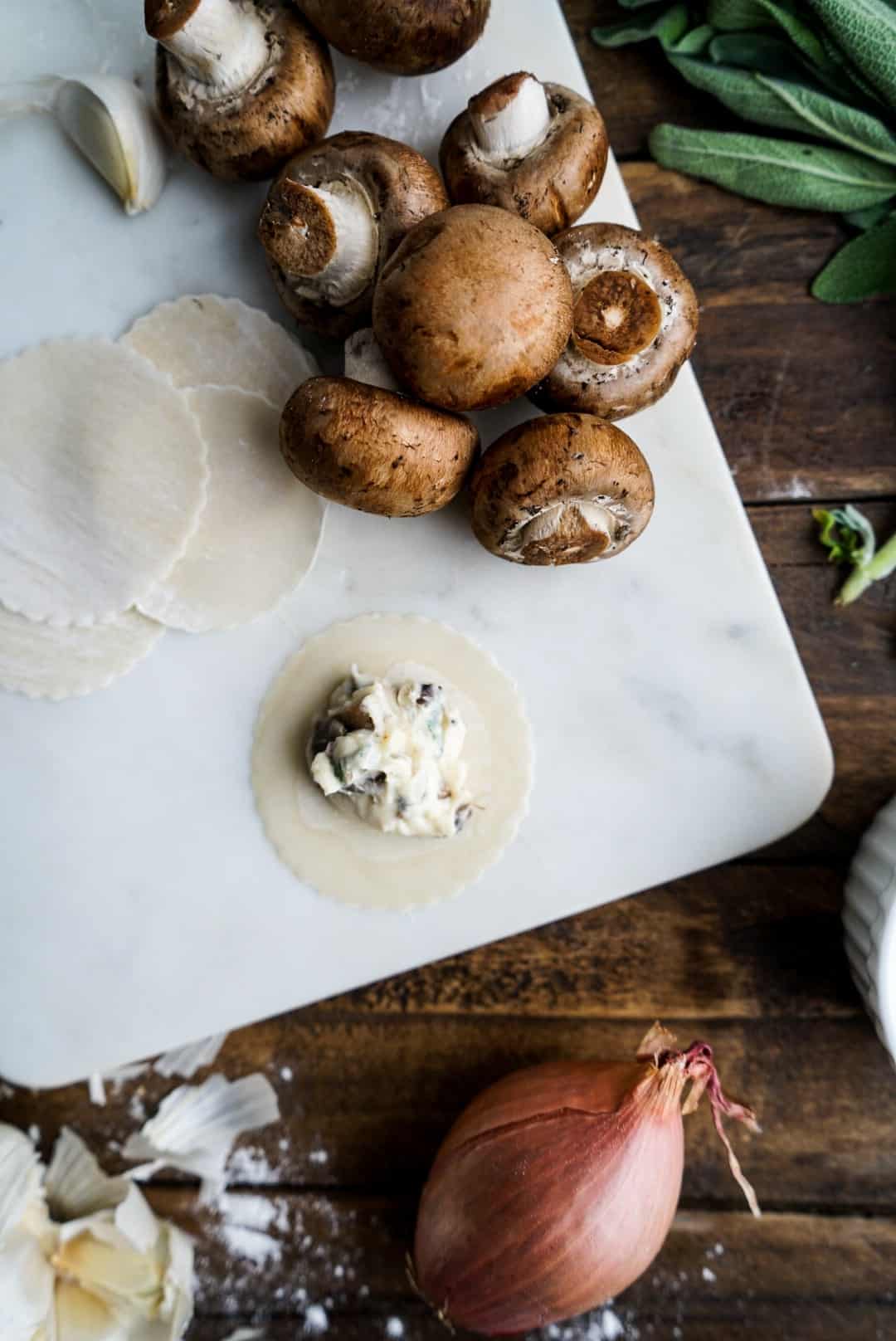Mushroom Ravioli with Brown Butter Sauce filling Mushroom Ravioli on prep board