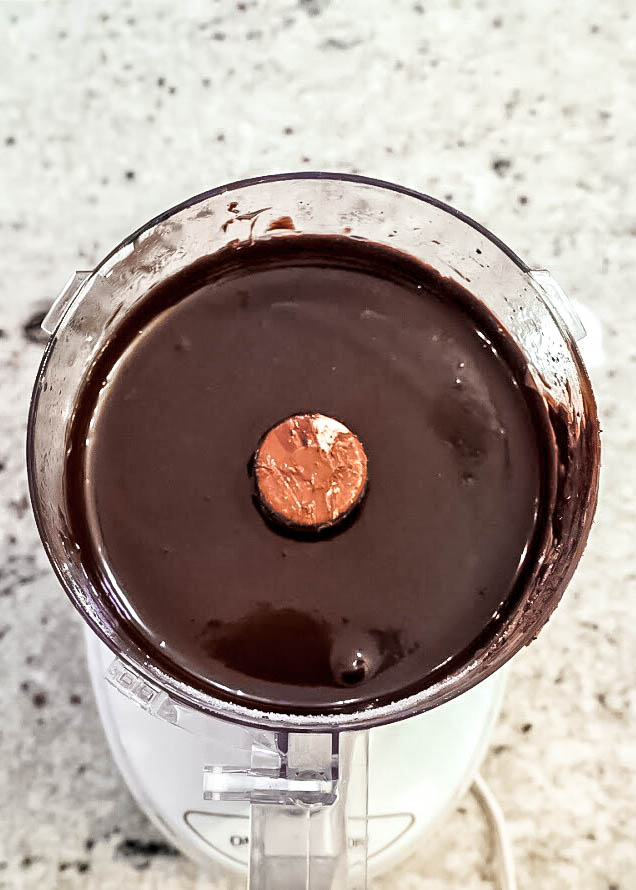 gluten free and vegan double chocolate tart Vegan chocolate tart filling blended until smooth and glossy in a food processor, creating a rich dairy-free chocolate mixture.
