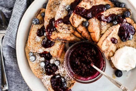 overhead shot of fluffy french toast with berry sauce and whipped mascarpone