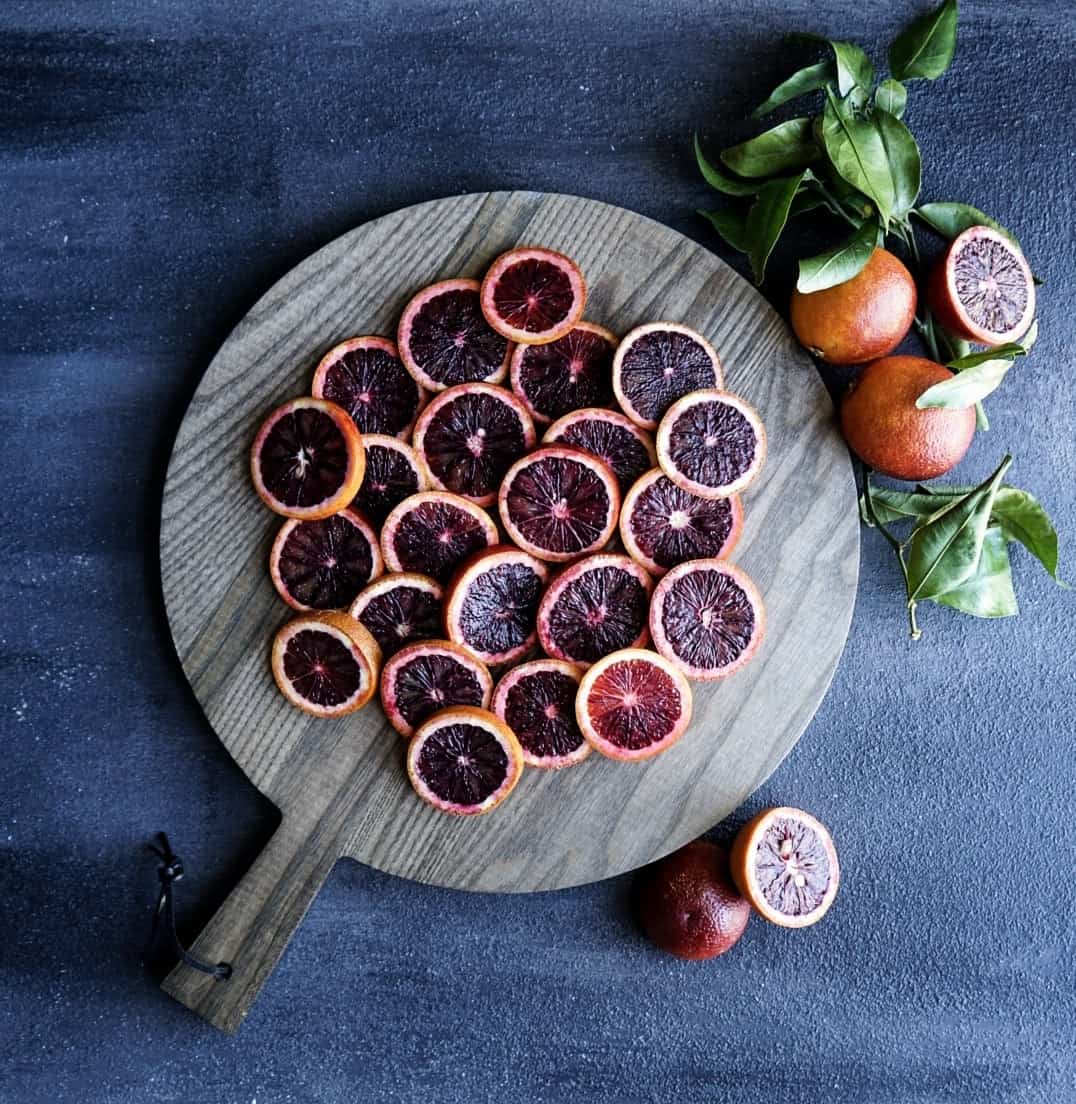 Hurricane Punch bowl Blood oranges sliced on cutting board