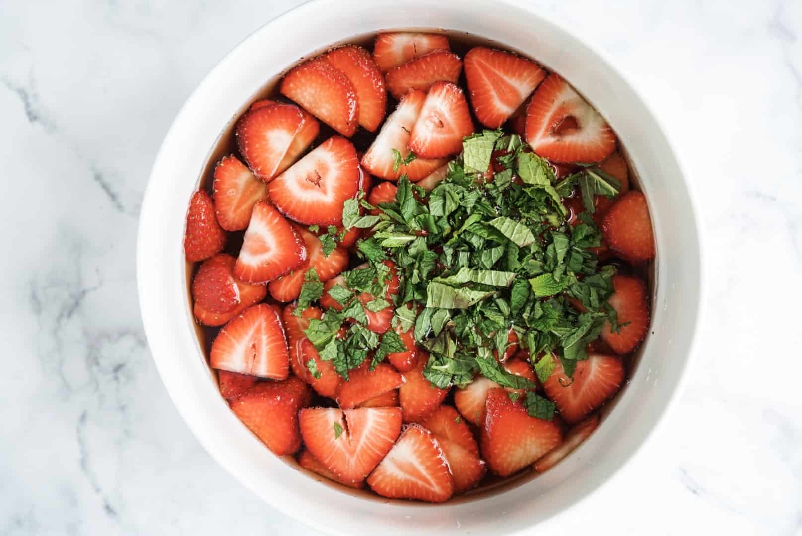 creamy rose sangria popsicles strawberries and mint in a bowl