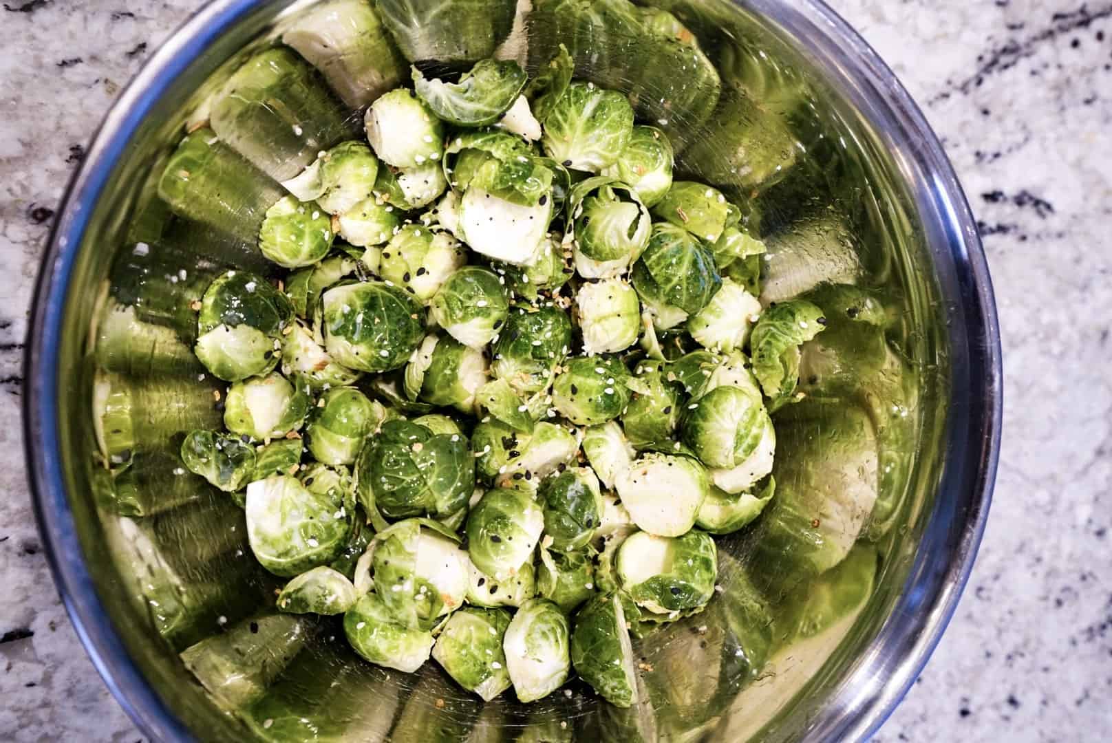 Crispy Air Fryer Asian Brussels Sprouts raw seasoned brussels sprouts in bowl