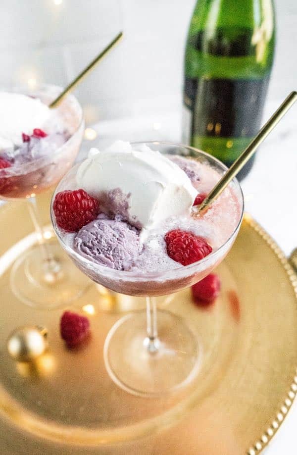 champagne floats with raspberries champagne floats with spoon and raspberries on serving tray
