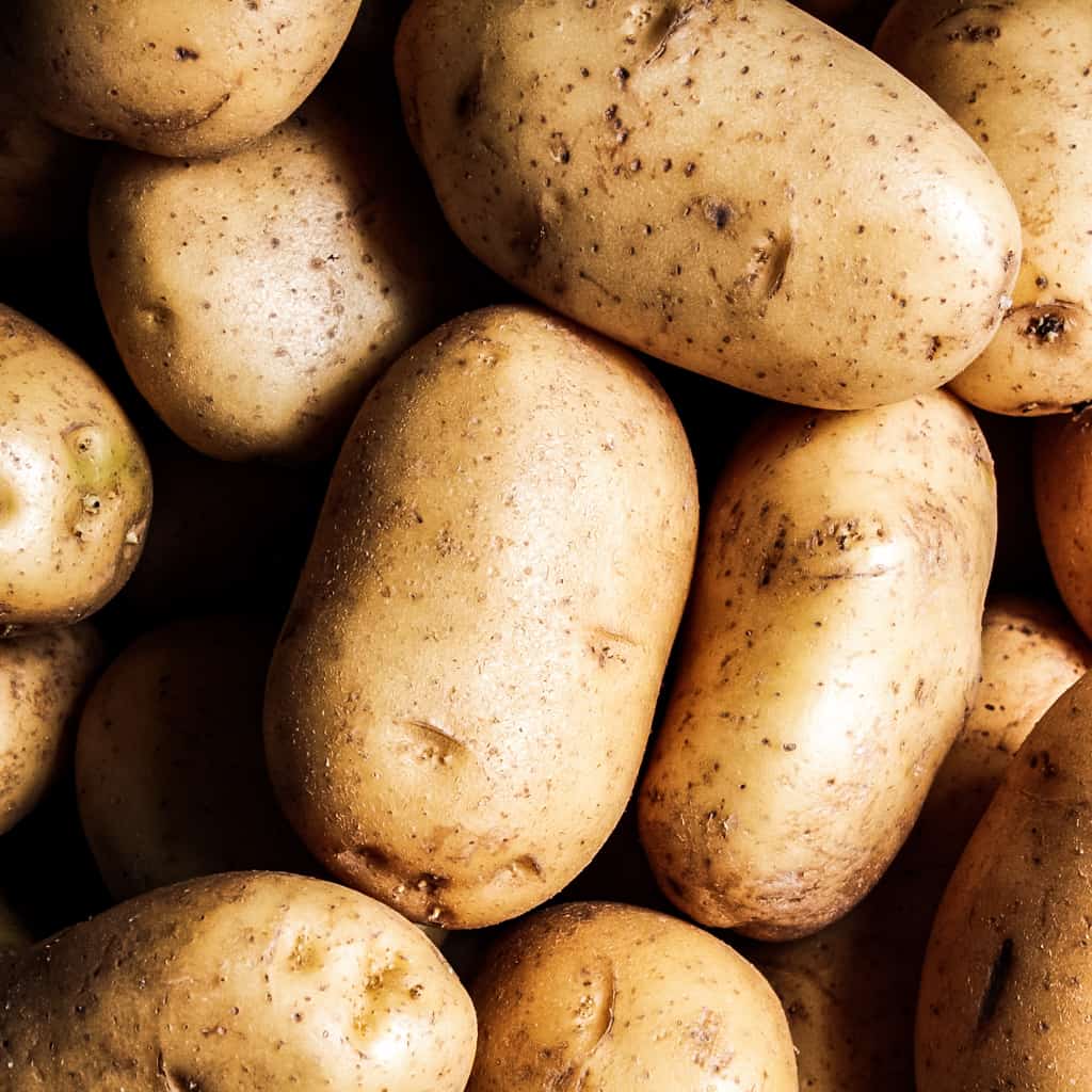 pile of russet potatoes with skin on