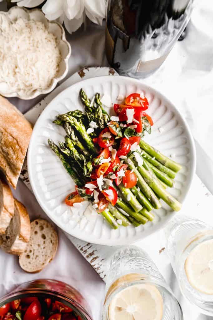 overhead shot of asparagus salad with marinated tomatoes