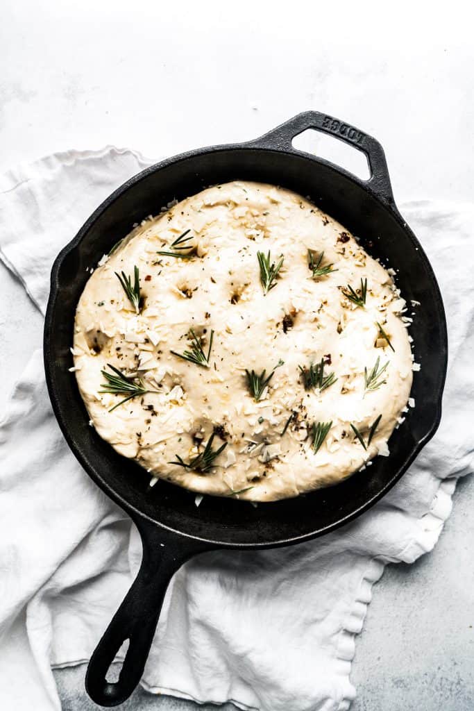 rosemary focaccia dough in cast iron pan