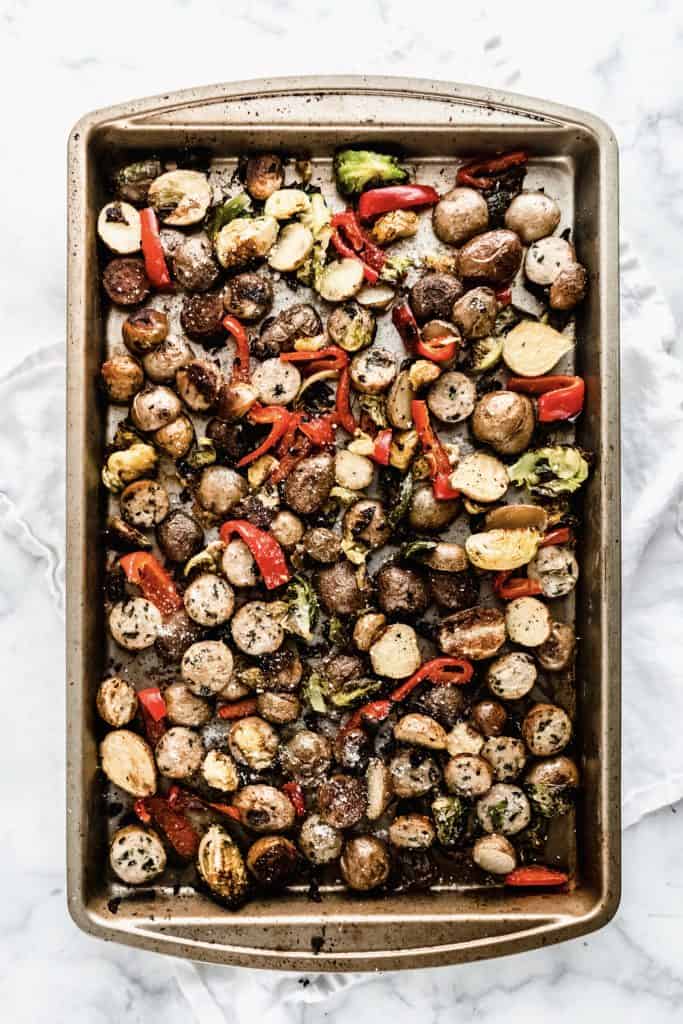 cooked sausage, veggies and potatoes on sheet pan