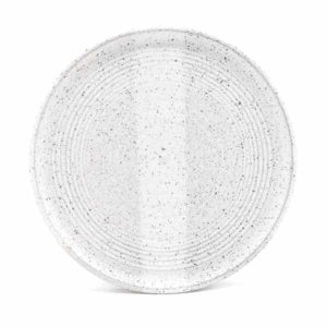 Top down view of a white speckled dinner plate on a white background