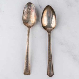 Top view of two vintage spoons on a marble background