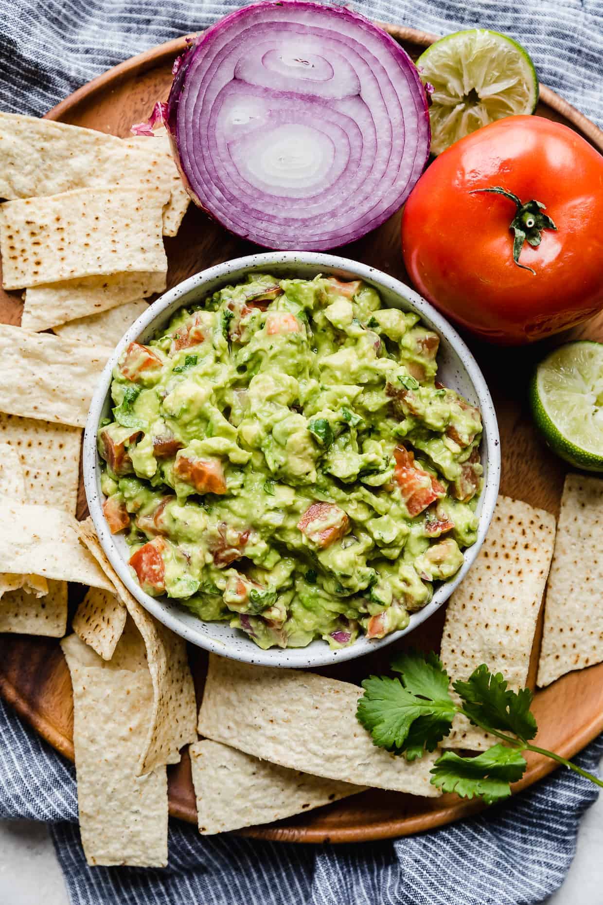 guacamole in bowl surrounded by tortilla chips