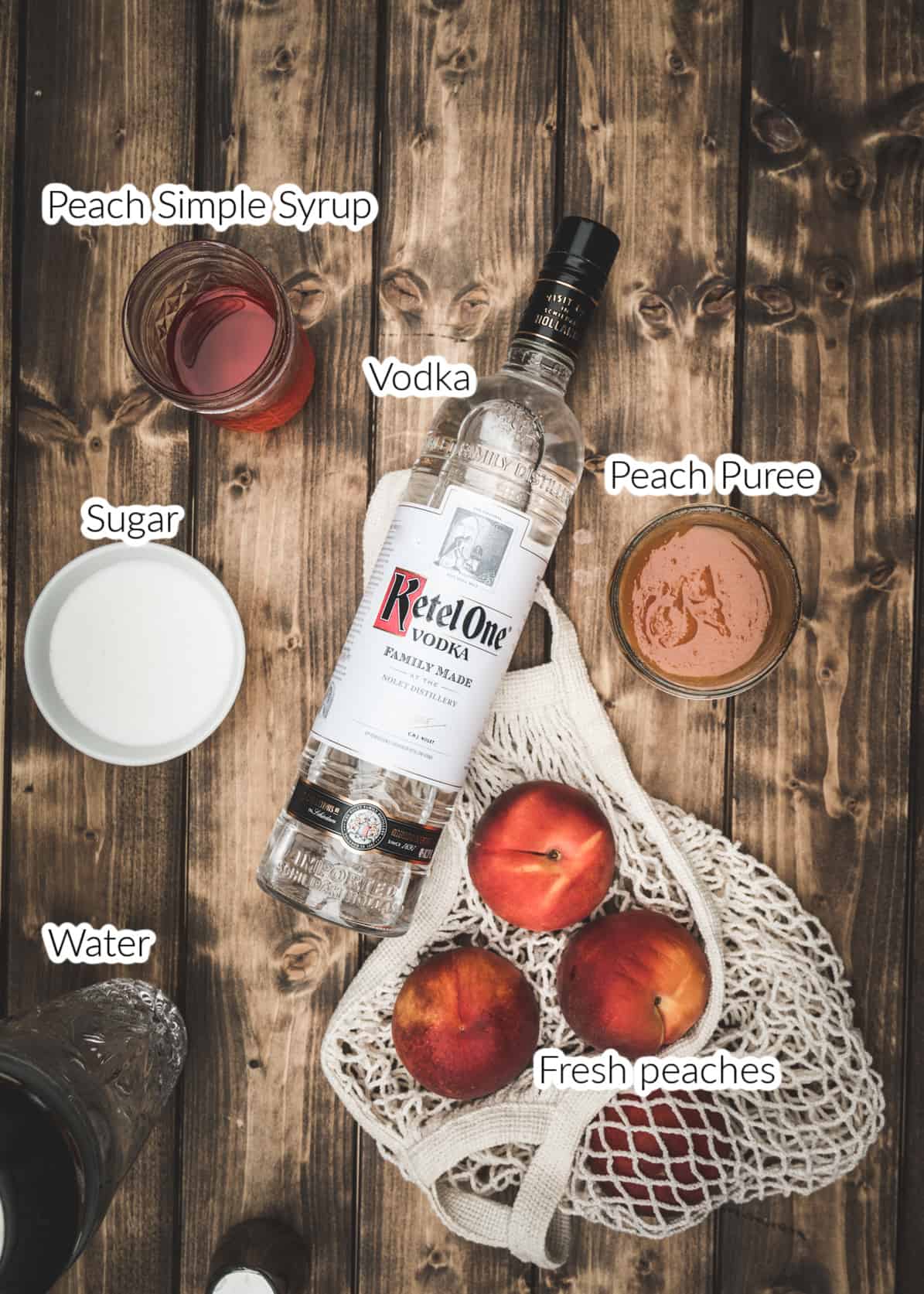 Peach vodka lemonade ingredients on wood board.