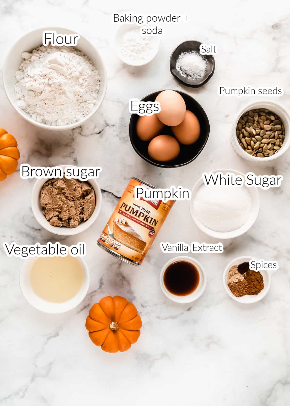 copycat starbucks pumpkin bread ingredients in small bowls on marble backdrop