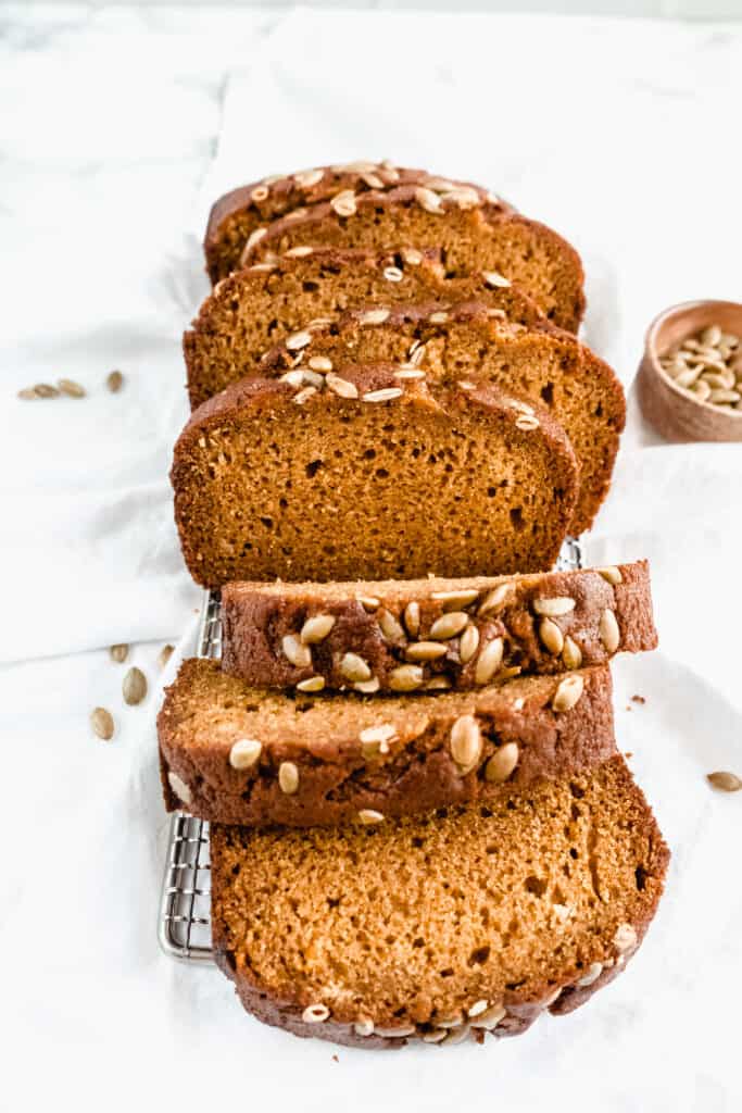 sliced pumpkin bread cascading on a cooling rack