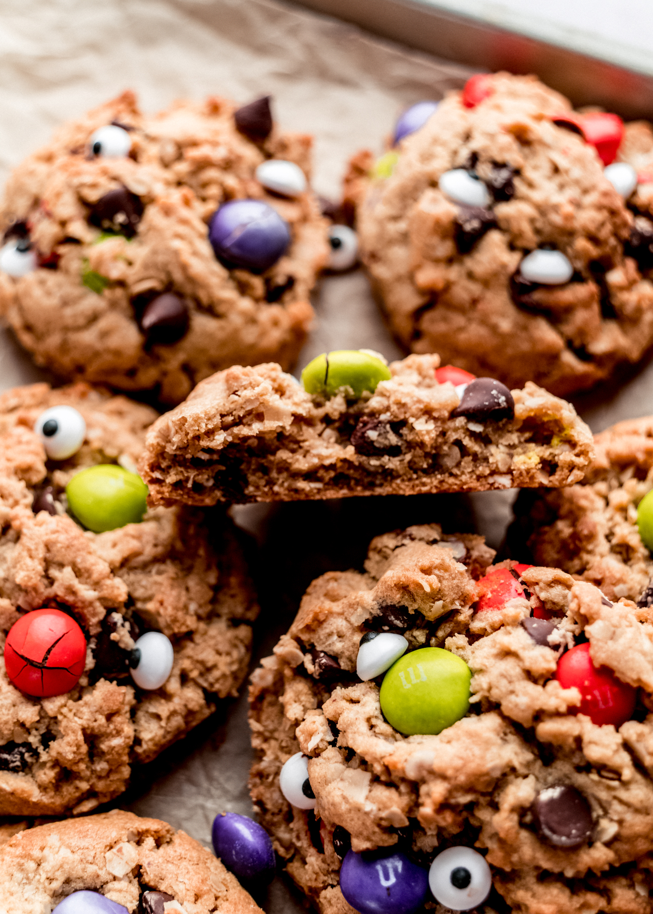 close up shot of Halloween monster cookie cut in half, showing chewy interior