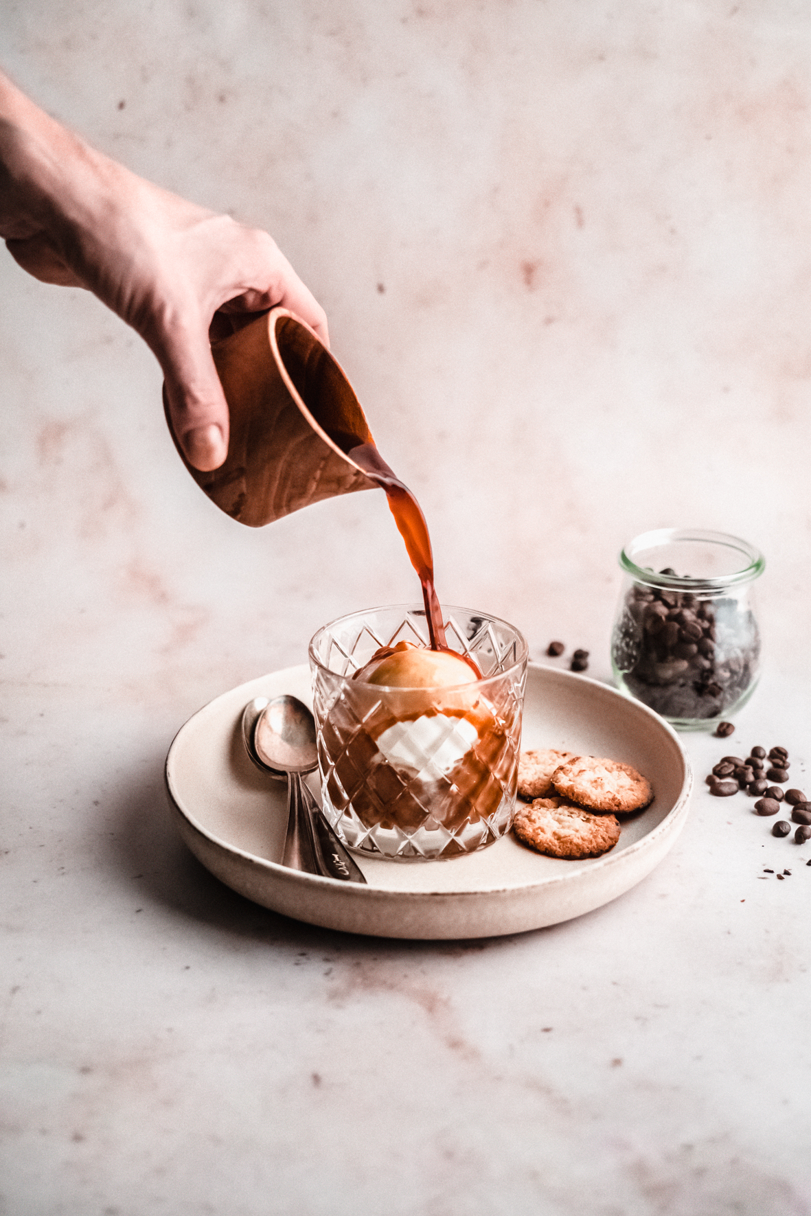 coffee being poured on affogato in dish with cookies