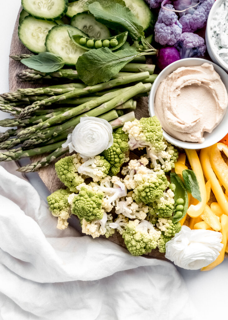 a close up shot of the green section crudité platter with asparagus, sliced cucumber, and romanesco