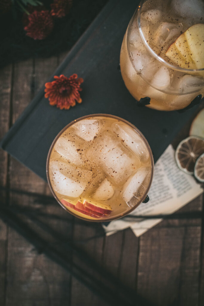 overhead shot of chai apple cider cocktail in skeleton cocktail glasses
