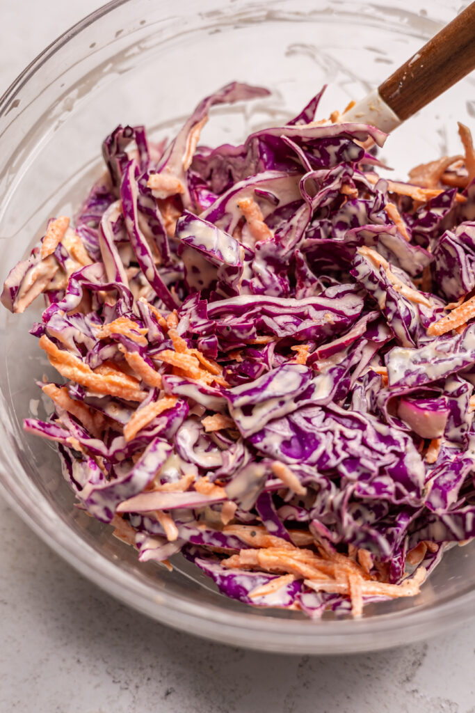 coleslaw in a bowl ready to go into the hot honey chicken bowls