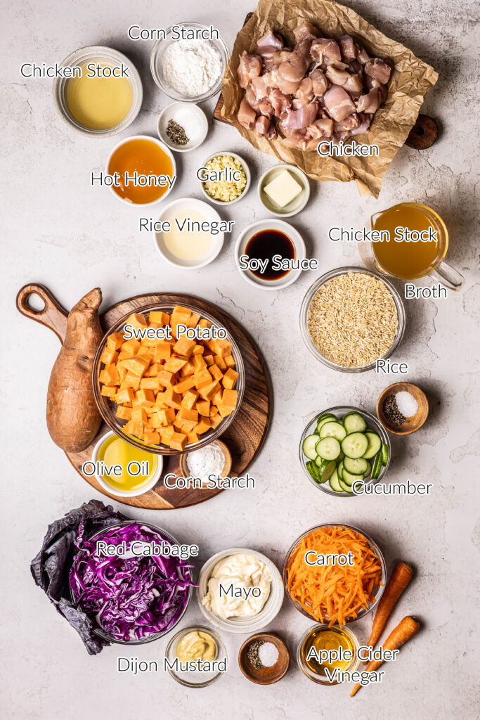 ingredients for hot honey chicken bowls in individual bowls on grey backdrop