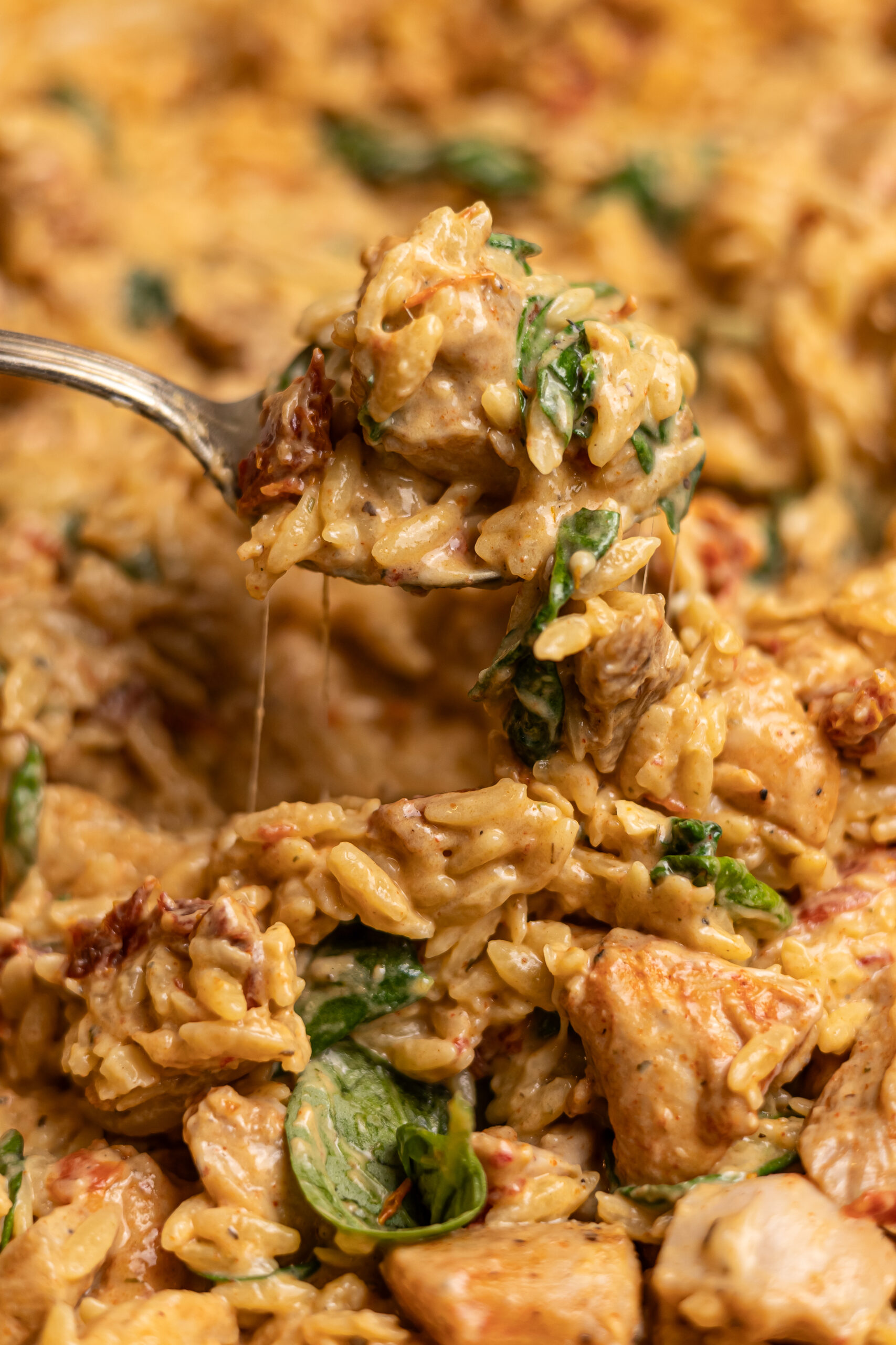 closet up shot of a fork scooping up marry me chicken orzo