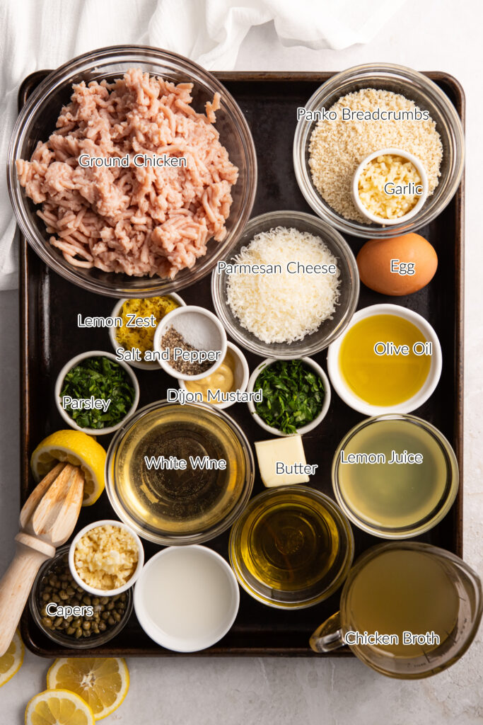 Chicken piccata meatball ingredients in individual bowls on a sheet pan