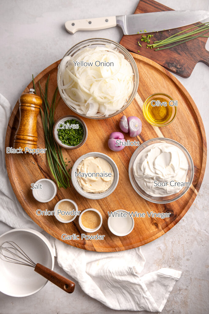 ingredients for homemade sour cream and onion dip on a wood platter